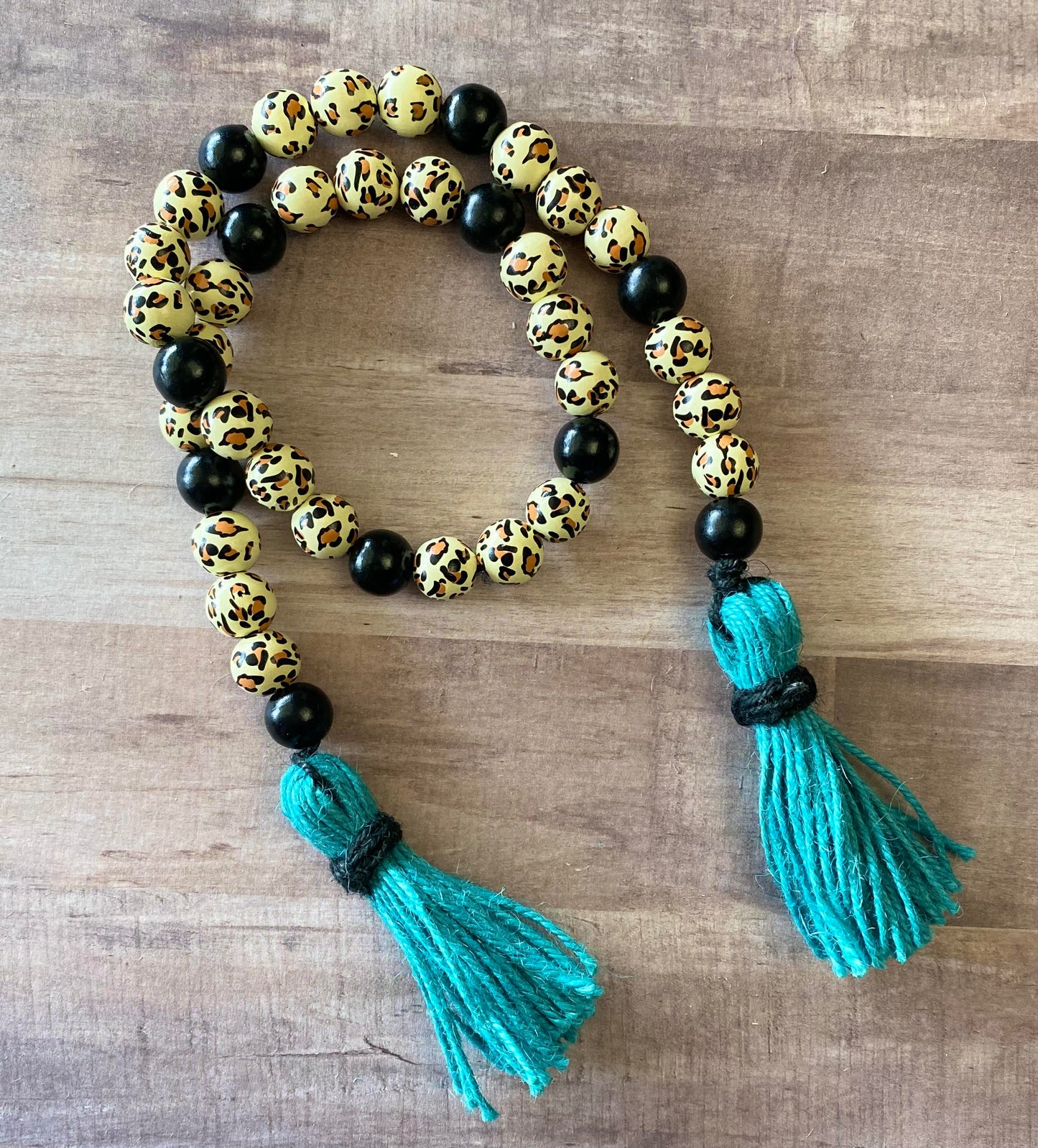 Cheetah Print Wooden Bead Garland with Turquoise Tassels